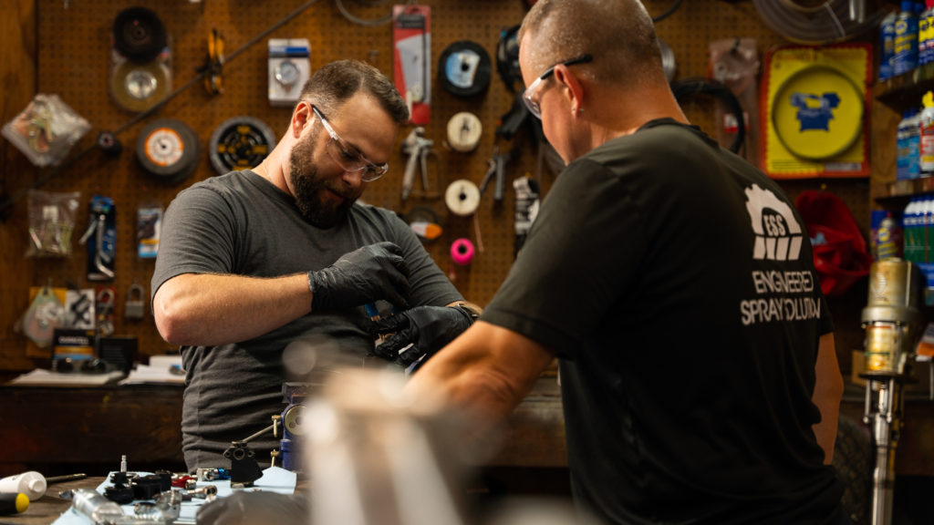 Sprayroq engineers working in a shop